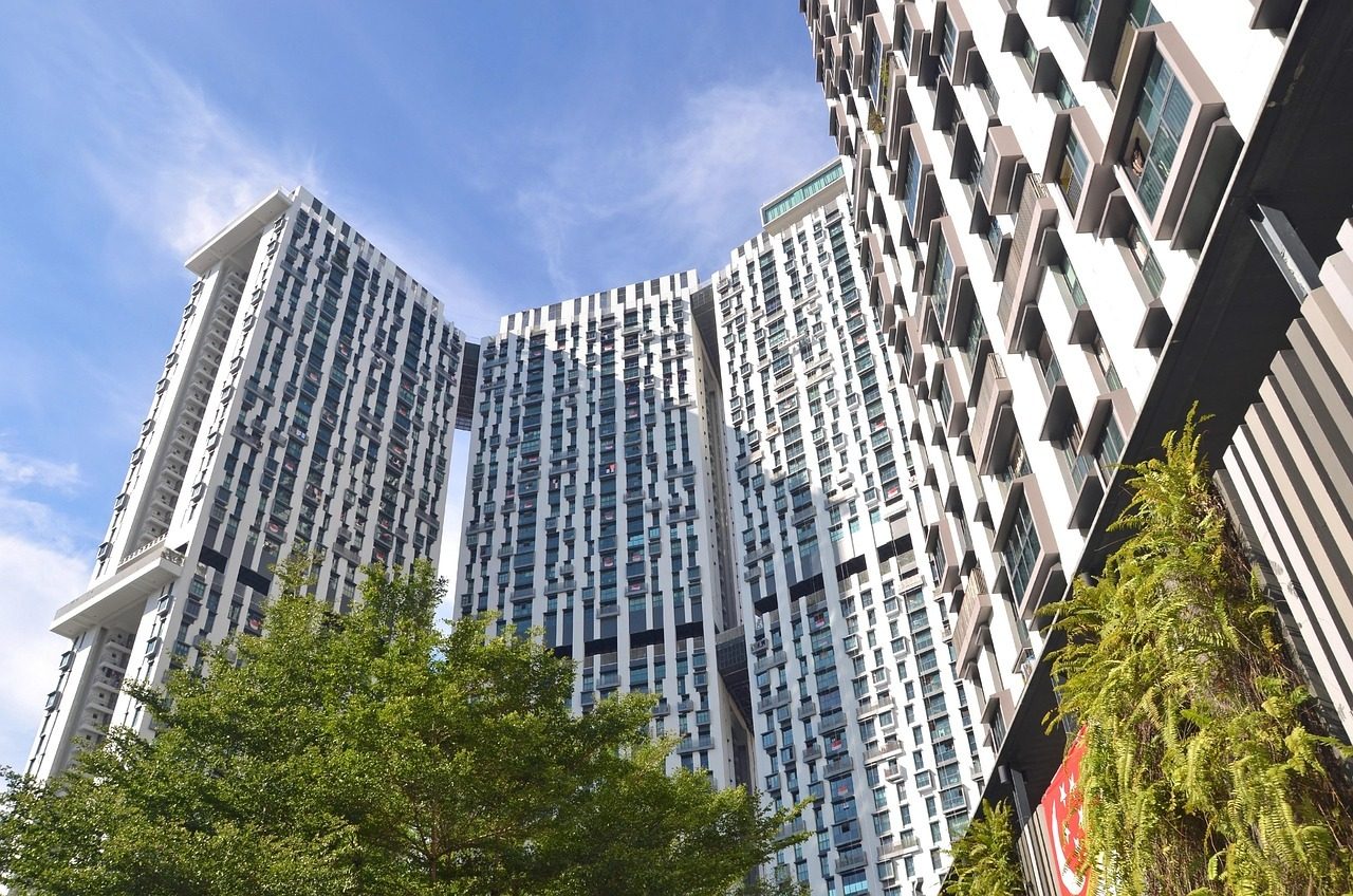 HDB flats for sale in Singapore, high-rise Pinnacle-style residential towers against a blue sky